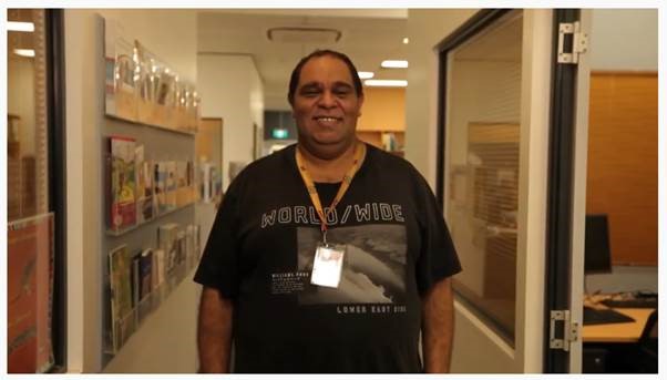 Aboriginal Mental Health worker standing in office and smiling