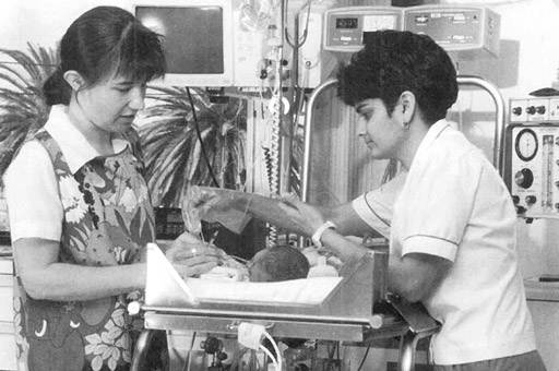 Nurses tending to a newborn baby.